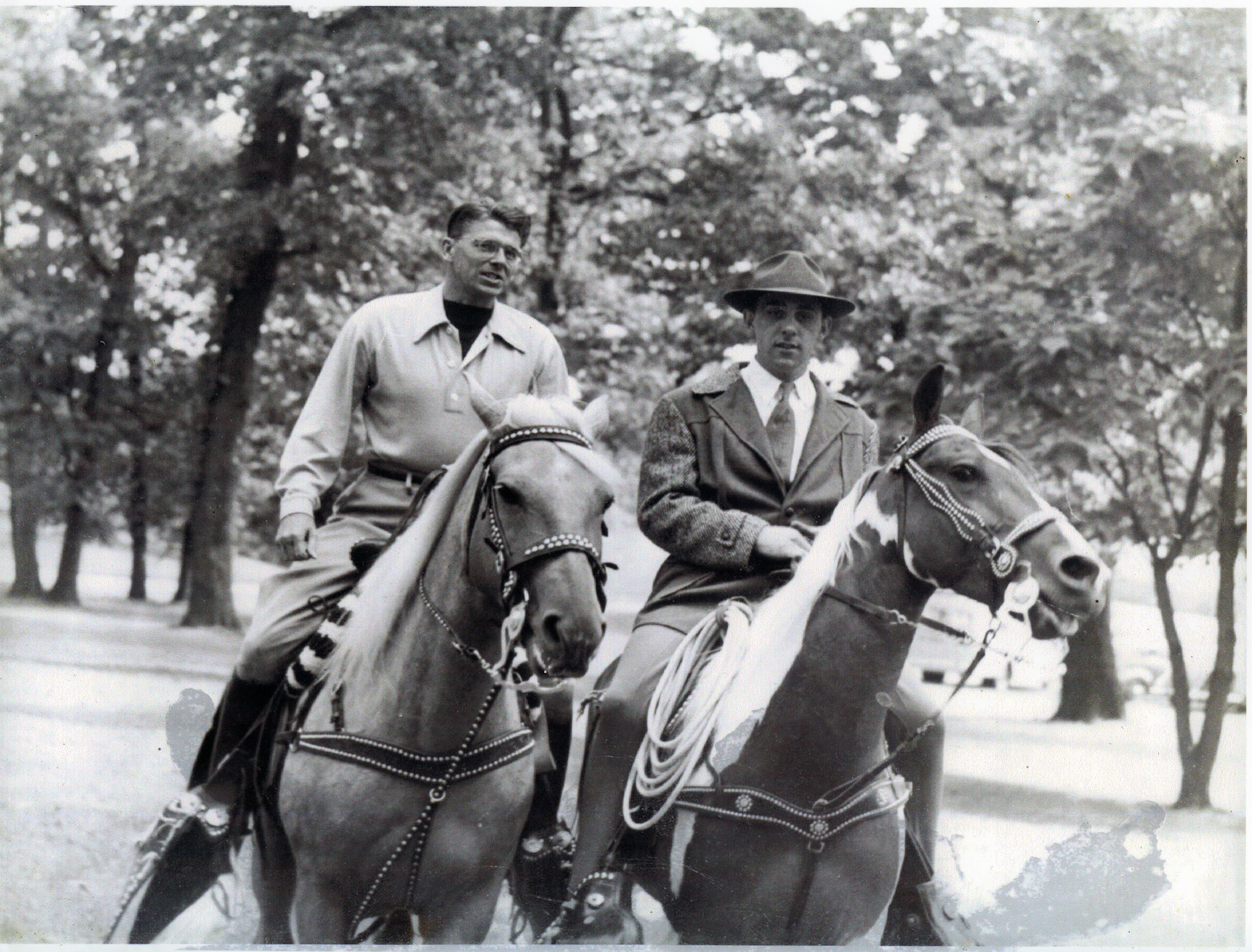 Ronald Reagan horseback riding with George McKee Hallam at the Pumpkin Festival in Eureka, Illinois