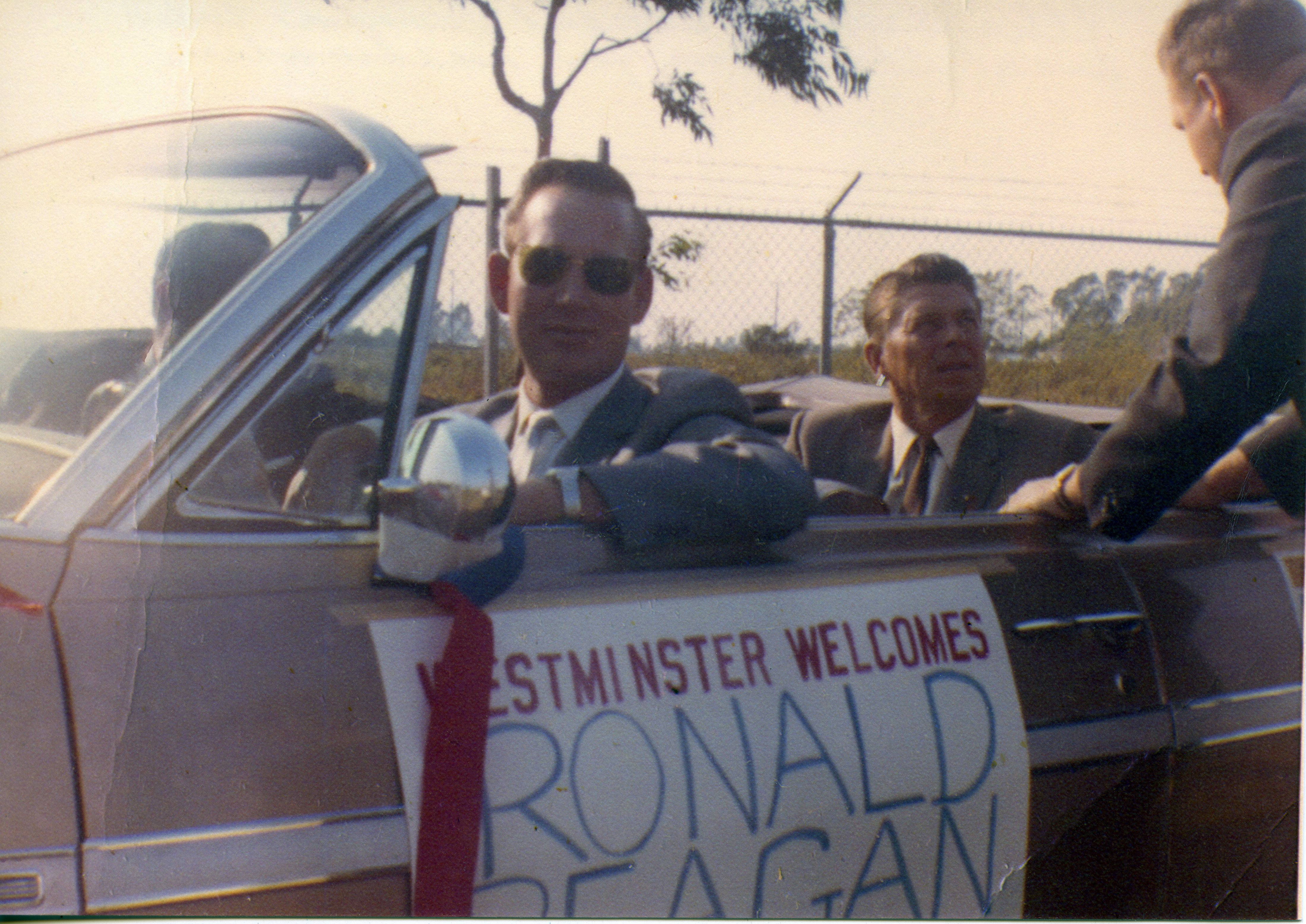 Ronald Reagan sitting in car while campaigning for Barry Goldwater