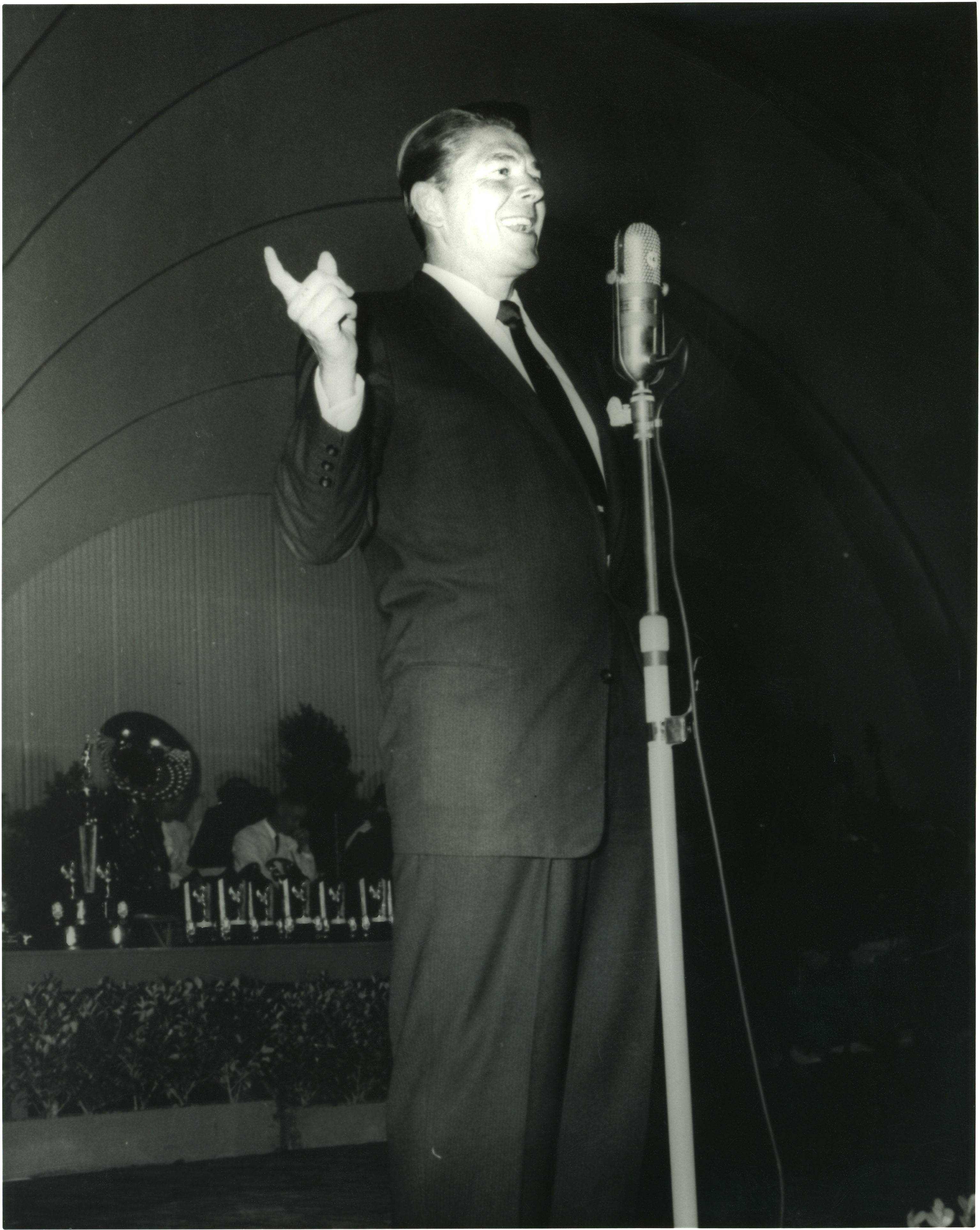 Ronald Reagan speaking at microphone, unknown event
