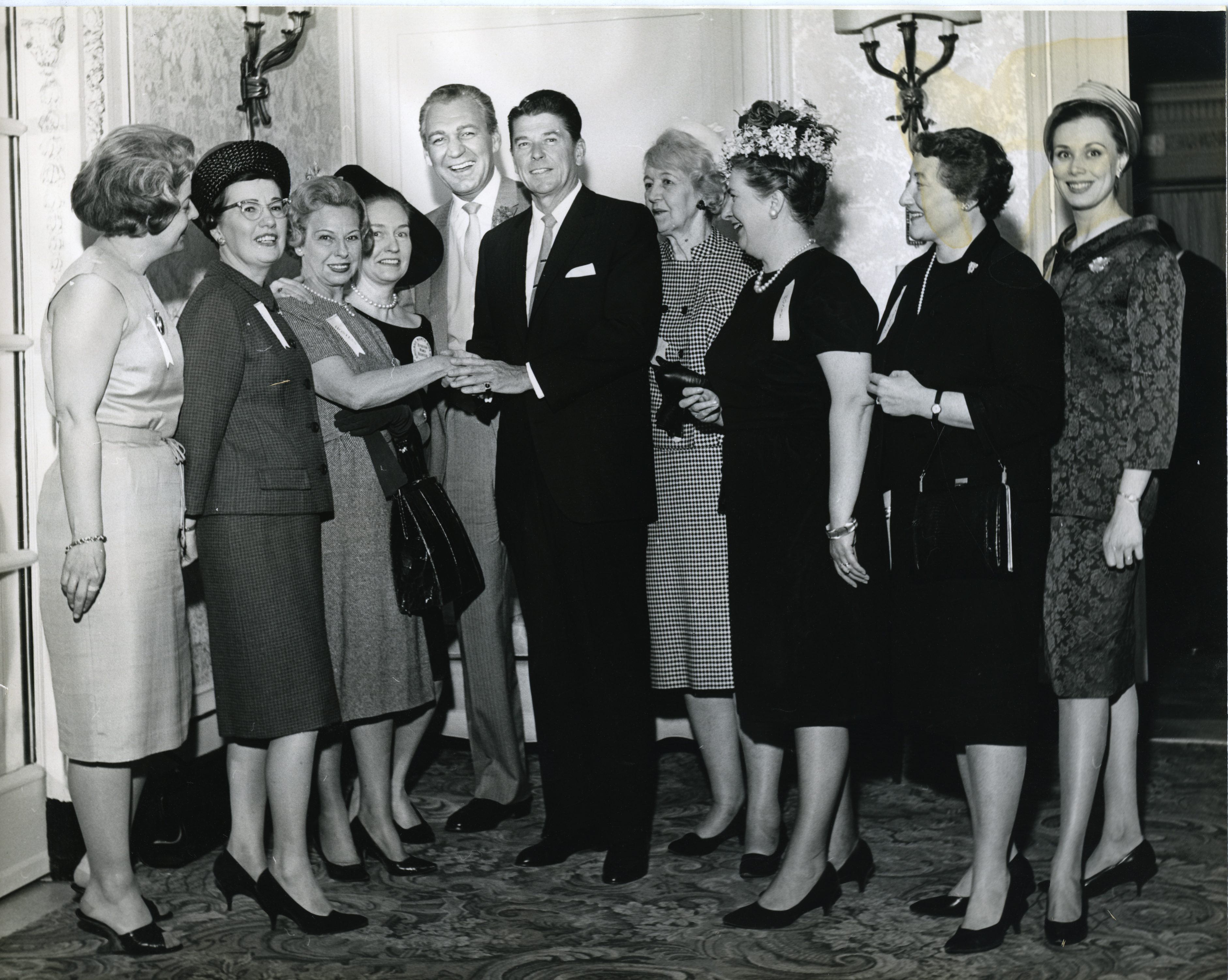 Ronald Reagan standing with Forrest Tucker and Grace Mace at a Luncheon in Chicago, Illinois