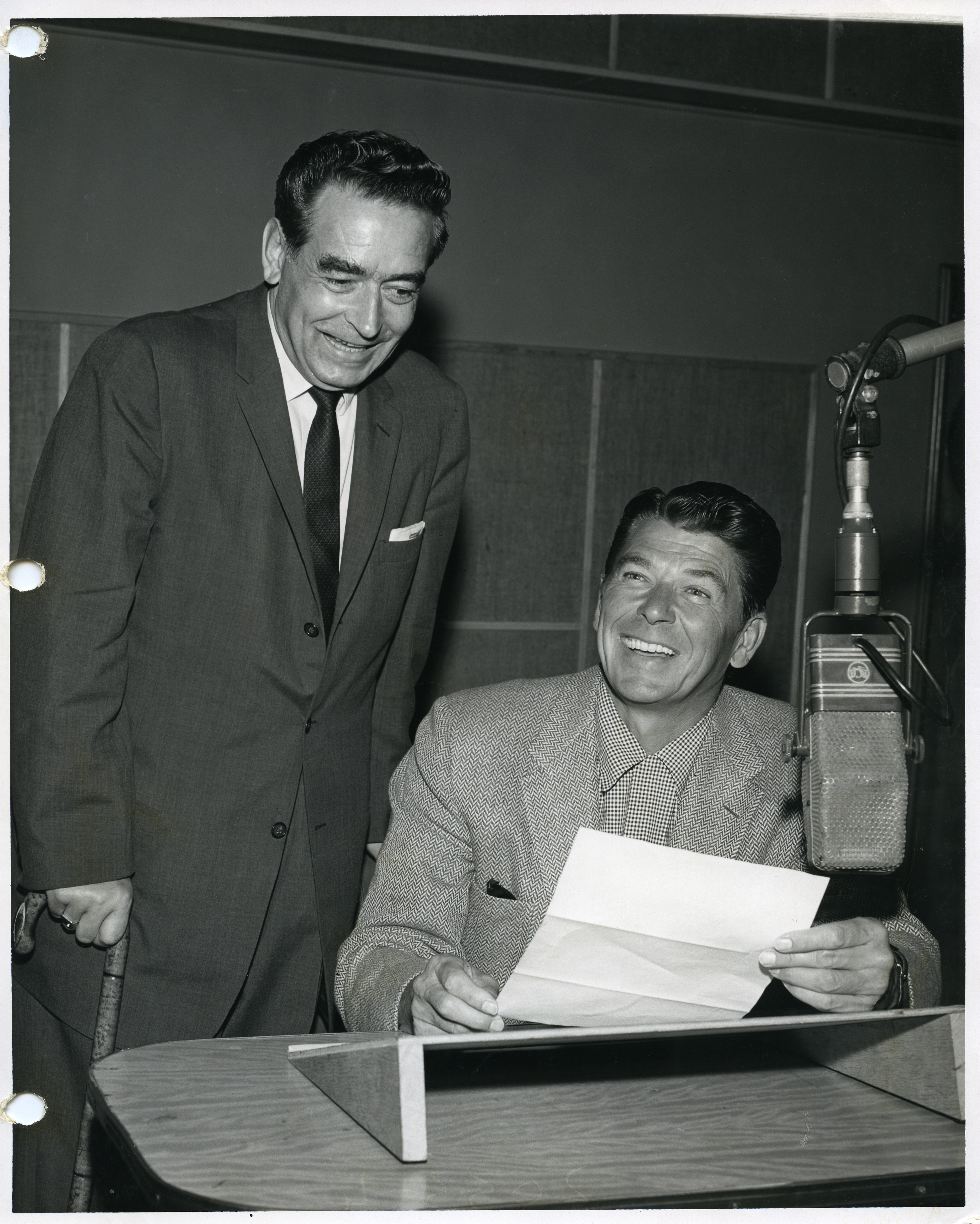 Ronald Reagan, in front of microphone, with George Heimrich, West Coast Director of the Broadcasting and Film Commission of the National Council of Churches at the Hollywood Facility