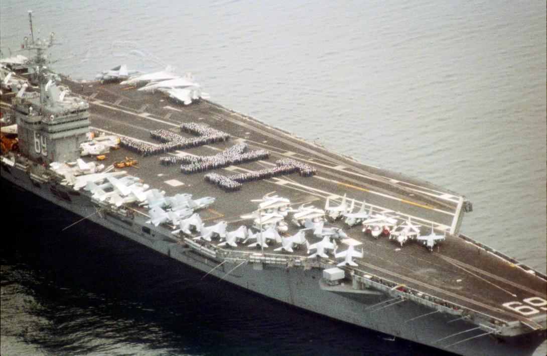 US Navy aircraft carrier USS Eisenhower (CVN-69) spelling out "Ike" with sailors on deck